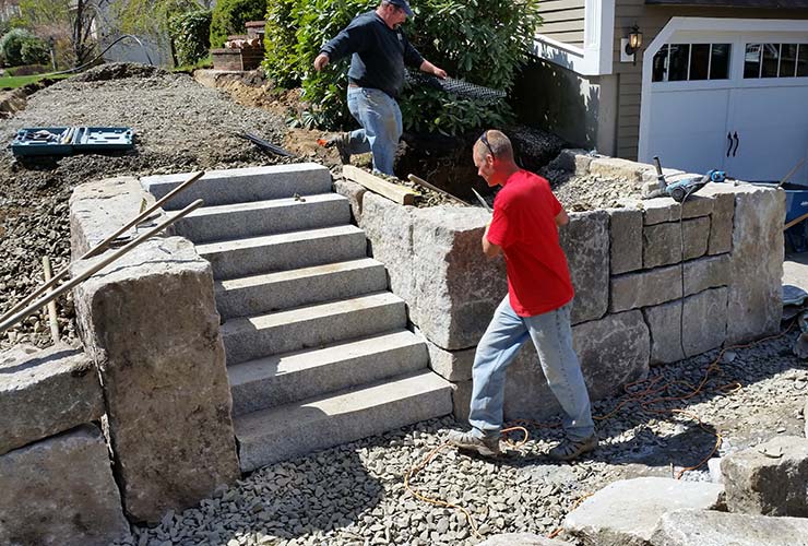 Natural stone retaining wall with granite steps